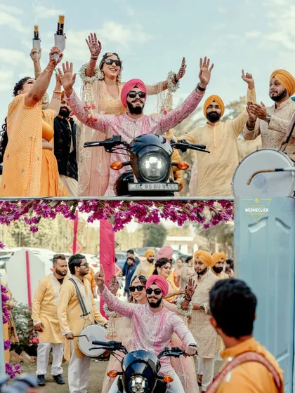 The groom makes a cool entry on a motorcycle with the bride riding pillion, a unique and fun start to their Haldi ceremony.