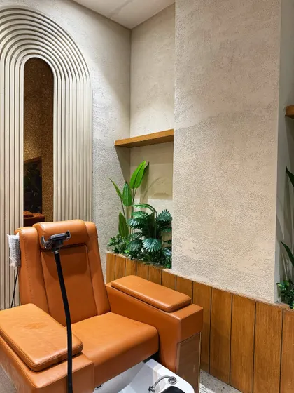 A close-up of our work at Looks Salon in Noida. We used a mix of high-quality artificial plants in this built-in planter to add a touch of green to the pedicure station, creating a relaxing vibe for clients.