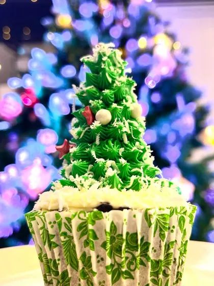 Sweeten your holidays with our festive Christmas muffins. This one is decorated to look like a Christmas tree, complete with frosting branches and sprinkle ornaments.