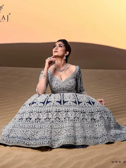 Grace your moment with this mesmerizing navy blue crop top Lehenga set, beautifully fused with sea green and silver embellishments.