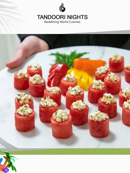 Refreshing watermelon bites topped with a savory crumble, presented on a clean white platter. A perfect, colorful appetizer for a summer event.