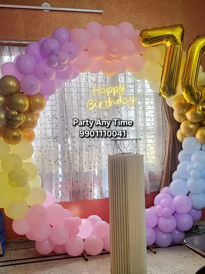A colorful pastel balloon ring for a 70th birthday celebration.