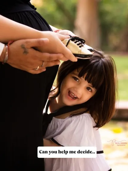 A playful peek-a-boo with the baby bump. Including older siblings in the photoshoot is a wonderful way to make them feel involved and excited about their new role.