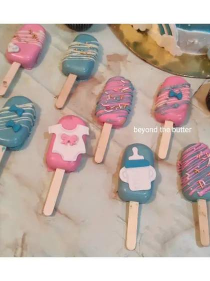 These baby shower cakesicles are almost too cute to eat. I decorated them in pink and blue with tiny bows, baby onesies, and milk bottles.