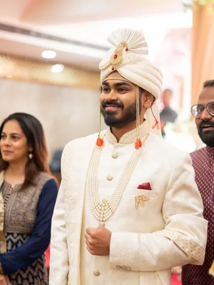 The groom's proud and happy expression as he waits for his bride.