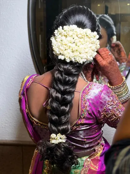A close-up of a beautifully finished traditional braid, ready for a bride's big day.