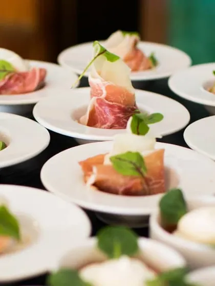 Prosciutto-wrapped melon is a classic Italian antipasto. The combination of sweet fruit and savory cured meat, presented on individual plates, is perfect for exclusive gatherings and wine-tasting events.