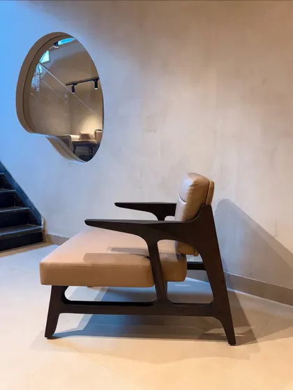 A side profile of our classic armchair, highlighting the elegant curves of the Shou-Sugi-Ban finished wood frame and the sleek armrests. It’s a timeless piece that exudes sophistication.