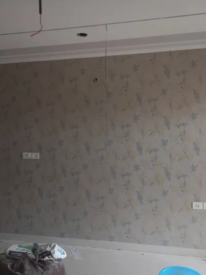 A subtle, textured wallpaper with a faint leaf pattern.