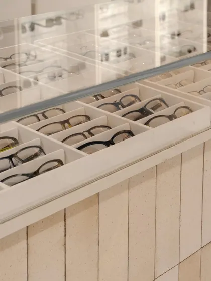 Custom-designed display drawers with individual compartments provide organized, accessible storage for eyewear, showcasing our attention to the functional needs of a retail environment.