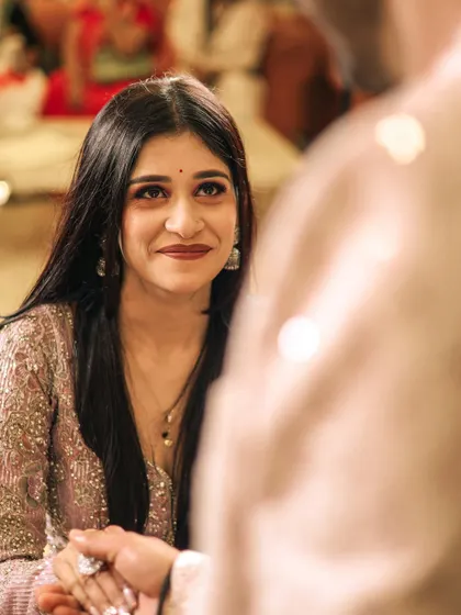The bride's emotional and loving gaze towards her partner during their engagement ceremony, a truly priceless moment.