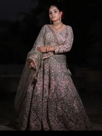 A full-length shot of the grey and pink lehenga, showing its beautiful flare and color combination.
