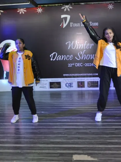 The duet dancers strike a powerful pose during their hip-hop routine.