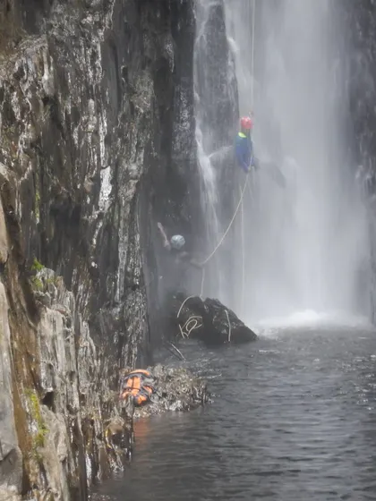 A successful descent, with the team regrouping in the pool below the waterfall before continuing the journey.