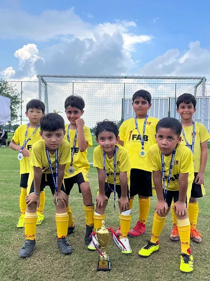 The team with their medals and trophy after the Pride Cup. These moments celebrate their hard work and dedication.