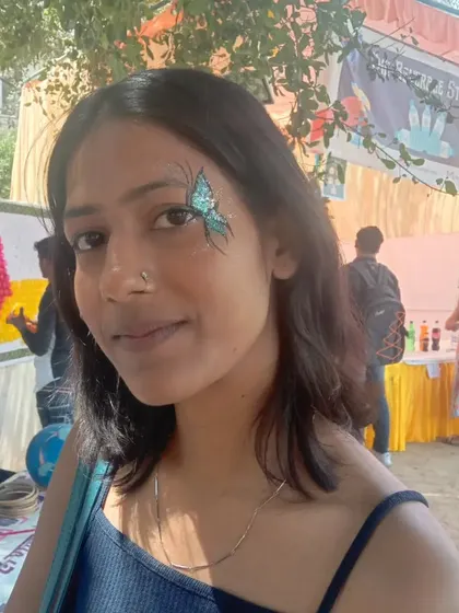 A full view of the sparkling teal butterfly design. You can see how it brightens up the face and adds a fun, festive vibe.