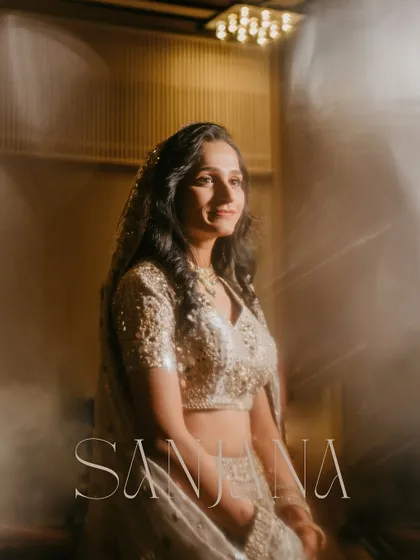 A soft and romantic portrait of the bride, with her name elegantly written. The dreamy light flare adds to the beauty of the moment.