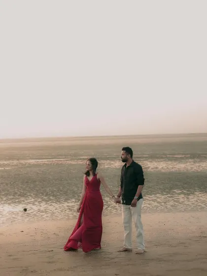 A minimalist composition of the couple against the vast ocean, perfect for a serene and artistic pre-wedding photo.