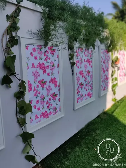 Details matter. We adorned a simple wall with framed floral prints and creeping ivy, turning it into a beautiful, photo-worthy backdrop.