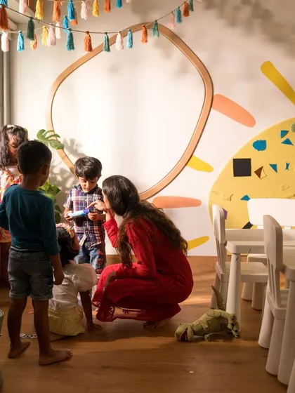 A teacher and children gathered in one of our bright, sunlit classrooms. We believe in creating a warm, interactive environment where every child feels seen and heard.