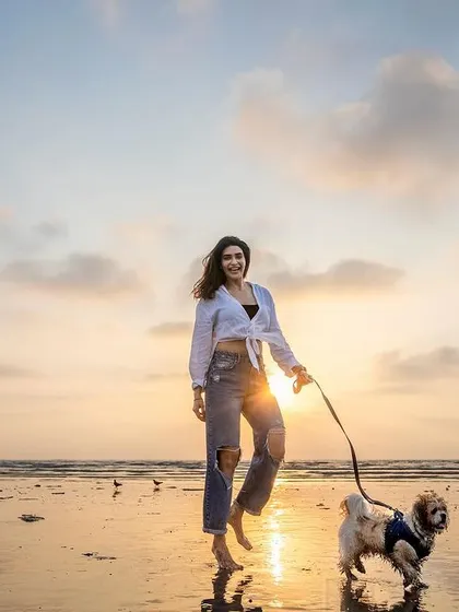 A beautiful sunset walk on the beach. The light, the reflections, and the bond between this owner and her dog make for a truly priceless memory.