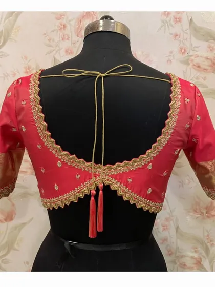 The full back view of the red cutwork blouse, showing the beautiful shape and detailed craftsmanship.