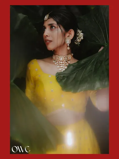 An artistic Haldi portrait with a red border and a dreamy, soft-focus effect.
