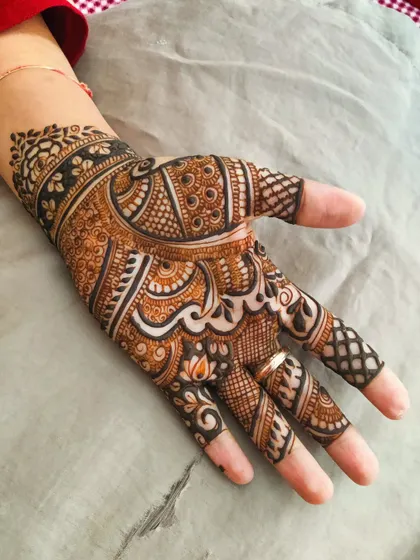 This stylish back-hand design is filled with intricate details. It combines paisleys, florals, and varied line work to create a pattern that is both dense and delicate.
