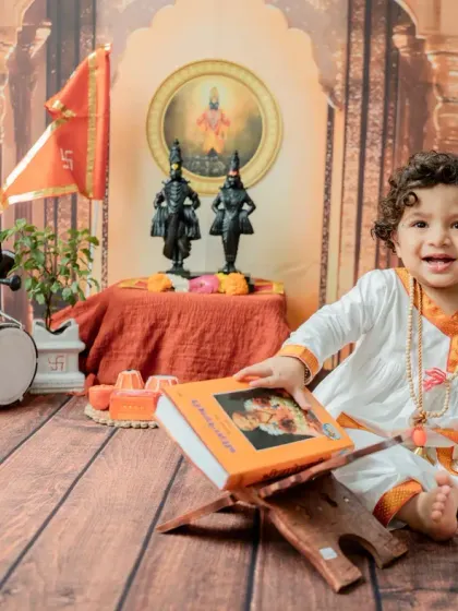 A happy, interactive moment as the baby touches the book. These photos highlight the curious nature of one-year-olds.