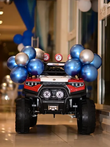 Make the birthday star's entrance unforgettable. I offer rental toy cars, like this decorated jeep, for the baby's grand entry, which is always a highlight of the party.