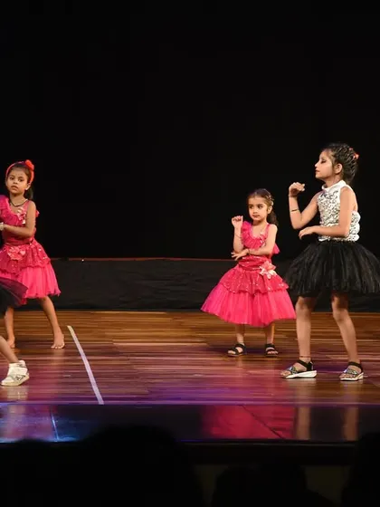 The girls striking a pose with confidence and attitude, showing off what they've learned in class.