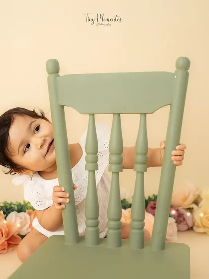 Another peek from behind the chair. These playful, candid moments make for the most memorable milestone photos.