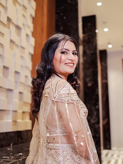 A side profile of Bhoomi's engagement look, showing off her soft curls and the beautiful sheen on her skin.
