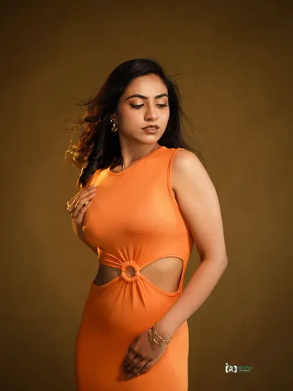 This shot demonstrates how a simple, solid-colored dress can pop in the studio. The clean background and focused lighting draw all attention to the subject's form and expression.