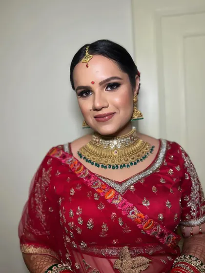 A close-up of the bride, her smile shining. The makeup enhances her natural beauty, making her look gorgeous.