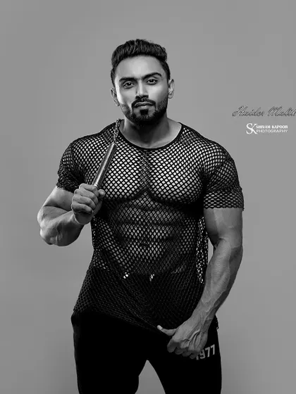The same shot in black and white, highlighting the shadows and muscle definition.