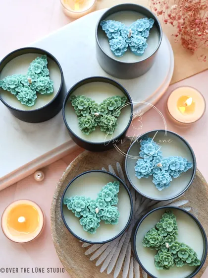 My green and blue 'Mariposa' butterfly candles. The detail on these is incredible, with tiny flowers forming the shape of the butterfly.