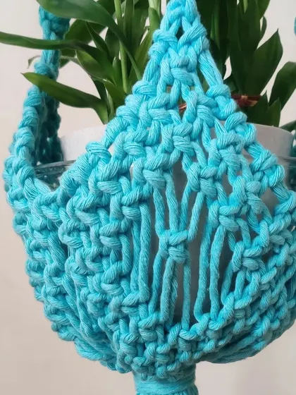 The bright blue color of this plant hanger is perfect for adding a pop of color.