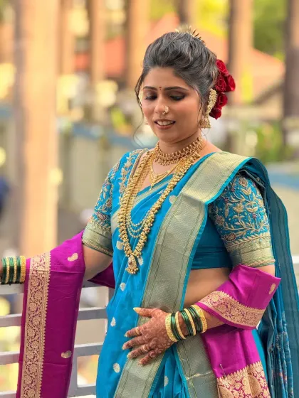 A beautiful shot of the bride on a balcony, showcasing her full look including the perfectly draped nauvari saree.