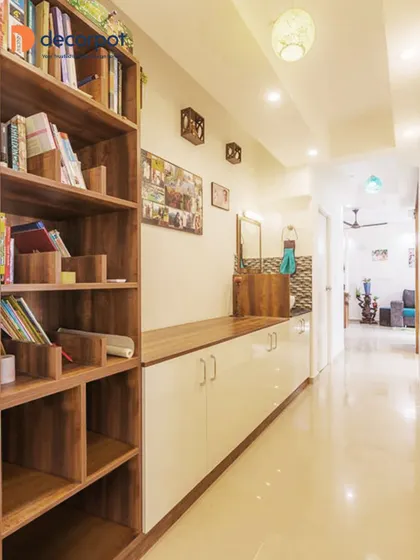 This long passageway is utilized effectively with a sleek console table and a tall bookshelf. It's a perfect example of how I can turn transitional spaces into functional storage and display areas.