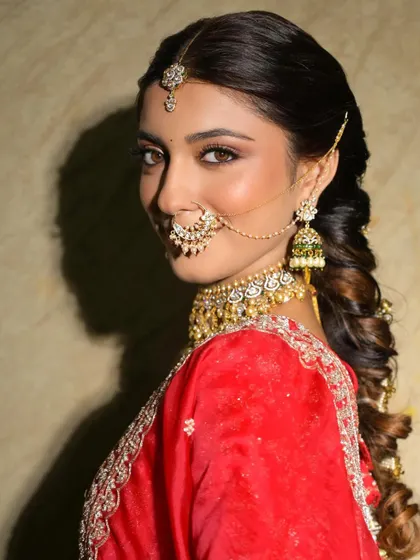 A side profile showcasing the beautiful hairstyle and the soft contour of her makeup. The look is polished and sophisticated.