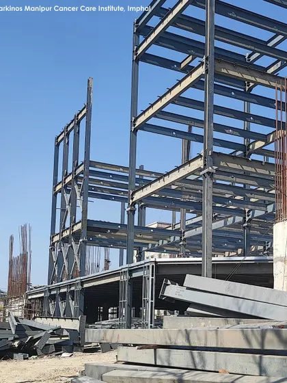 The steel frame of the Karkinos Manipur Cancer Care Institute during construction. The use of a steel structure allows for large-span, efficient spaces and faster construction, which is critical for healthcare projects.