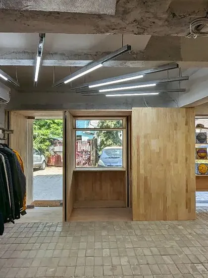 A wide shot of the empty retail floor under neutral lighting, emphasizing the spatial layout and material palette.
