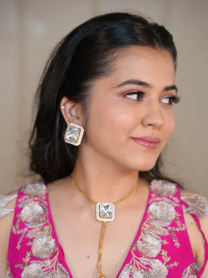 A side profile showcasing the soft pink eyeshadow and glowing highlighter. This romantic makeup is all about enhancing, not covering.
