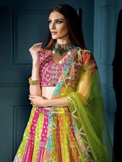 A close-up portrait that captures the rich colors of the blouse and the elegant green necklace. The model's pose and expression add a touch of grace to this ethnic look.