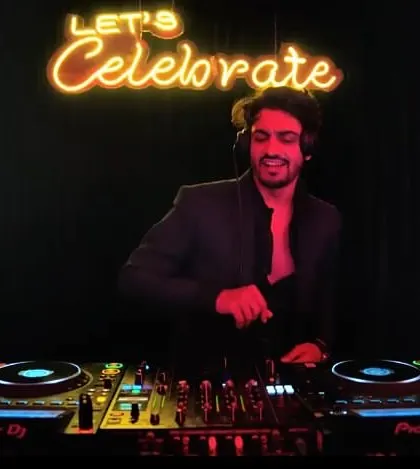 Let's Celebrate. The neon sign says it all. A clean, stylish shot of me at the decks, ready to start the party.
