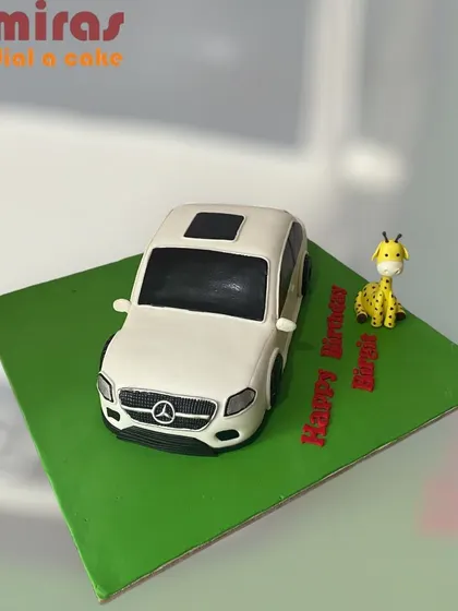 A sculpted cake that looks just like a white Mercedes-Benz SUV. This is a great example of my ability to create realistic, 3D car cakes for a special birthday.
