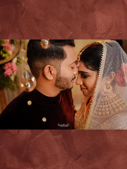 An intimate portrait of a bride and groom, their foreheads touching in a moment of quiet connection. The warm tones add to the romantic feel of this wedding photo.