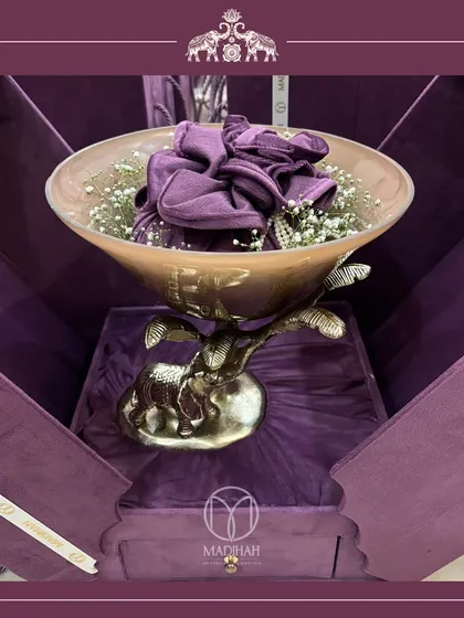 A close-up of the Elephant Bowl within its deep purple, custom-fit box. The presentation is as important as the gift itself, and I ensure every detail contributes to the luxury experience.