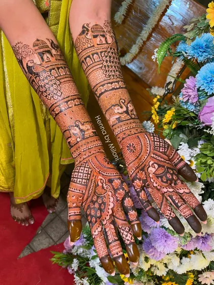 For the bride who loves classic motifs. This design features peacocks perched on jharokhas, swans, and elephants, all woven together with intricate patterns for a timeless bridal henna look.